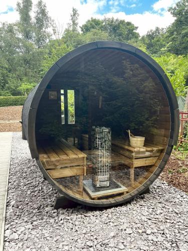 a large circular building with a bird in it at Serenity Lodge Durbuy - Sauna & Jacuzzi in Durbuy