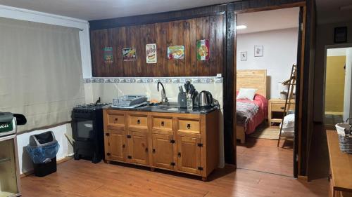 a kitchen with a sink and a stove in a room at Casa Chuy Barcelona in Chuy