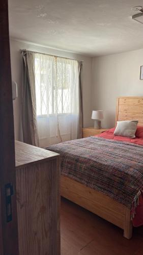 a bedroom with a large bed and a window at Casa Chuy Barcelona in Chuy