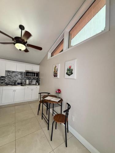 a kitchen with a table and a ceiling fan at Pyramid Studio + free parking&wifi/ 5%off in Tampa