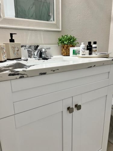a bathroom counter with a white sink and a mirror at Pyramid Studio + free parking&wifi/ 5%off in Tampa