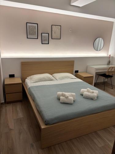 a bedroom with a bed with two towels on it at Sofia's Home in Chania Town