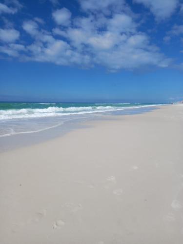 a sandy beach with the ocean in the background at Double Take! Renovated Vacation Home in Panama City Beach