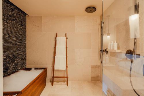 a bathroom with a shower and a bath tub at Nobu Hotel Los Cabos in Cabo San Lucas