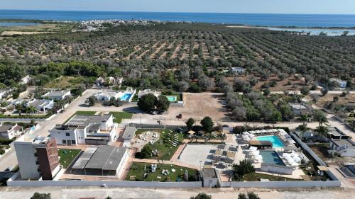 an aerial view of a resort with the ocean in the background at Boomerang Village in Torre Colimena