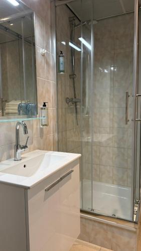 a bathroom with a sink and a shower at Tung Hotel in Zeewolde