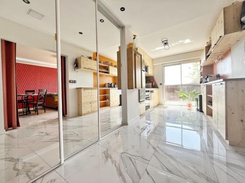 a kitchen with glass doors and a dining room at Delrio in Nantes
