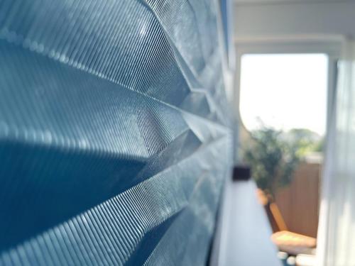 a close up of a window with a blue net at Delrio in Nantes