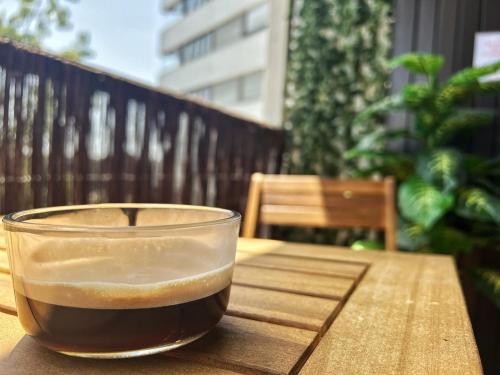 a cup of coffee sitting on top of a wooden table at Delrio in Nantes