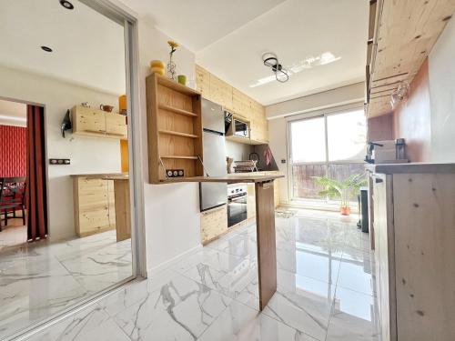 a kitchen with a counter and a large window at Delrio in Nantes