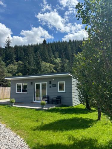 a tiny house in the middle of a yard at Rowan Bank Retreat in Fort Augustus