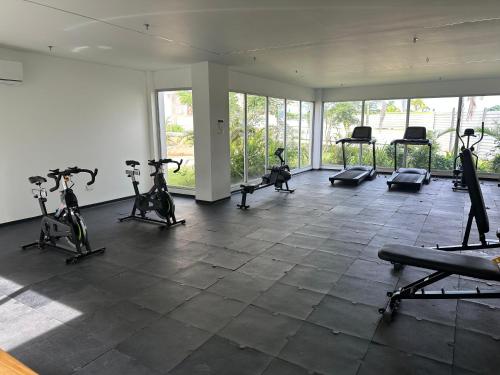 a gym with exercise bikes in a room with windows at baia kristal paraiso aguas cristalinas in Cartagena de Indias