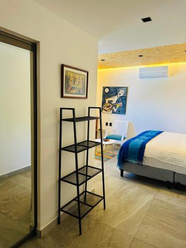 a bedroom with a bed and a ladder next to a bed at The Quetzal in Cancún