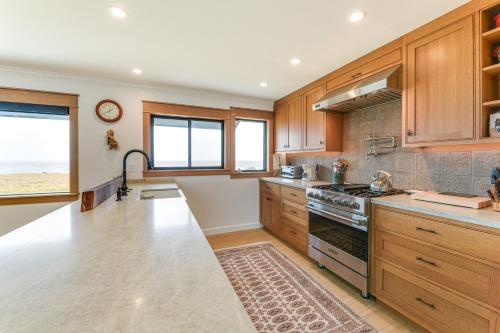 a kitchen with wooden cabinets and a stove top oven at Walk to Beach Luxury Oceanfront Escape in Caspar in Caspar