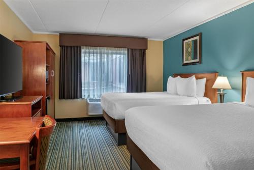 a hotel room with two beds and a television at Best Western Plus Traverse City in Traverse City