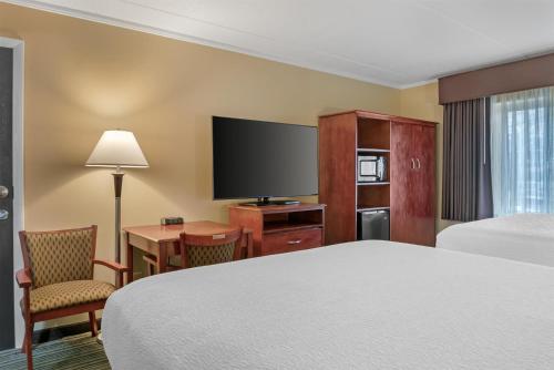 a hotel room with a bed and a flat screen tv at Best Western Plus Traverse City in Traverse City