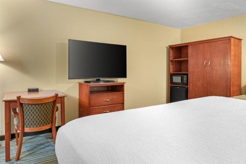 a hotel room with a bed and a flat screen tv at Best Western Plus Traverse City in Traverse City