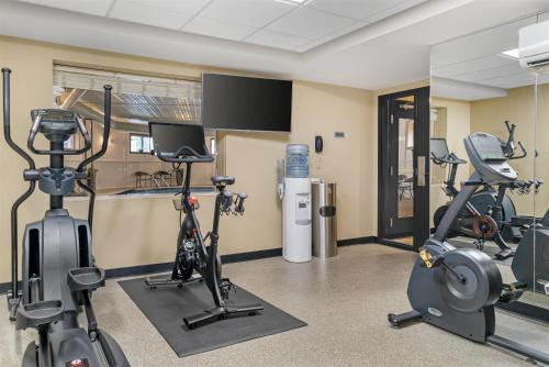 a gym with treadmills and exercise bikes in a room at Best Western Plus Traverse City in Traverse City