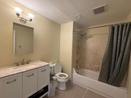 a bathroom with a toilet and a sink and a shower at Private Room "Cherry" by UW in Seattle