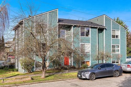 a blue house with a car parked in front of it at Private Room "Cherry" by UW in Seattle