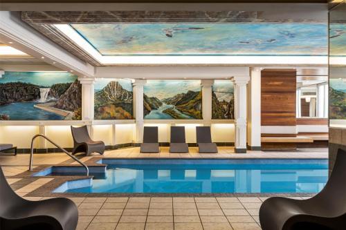 a pool in a hotel lobby with a painting on the wall at Best Western Plus City Centre Centre-Ville in Quebec City
