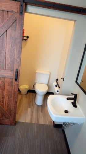 a bathroom with a toilet and a sink at Willow e-hotel in Mattoon