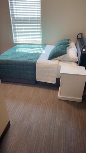 a bedroom with a bed and a wooden floor at Willow e-hotel in Mattoon