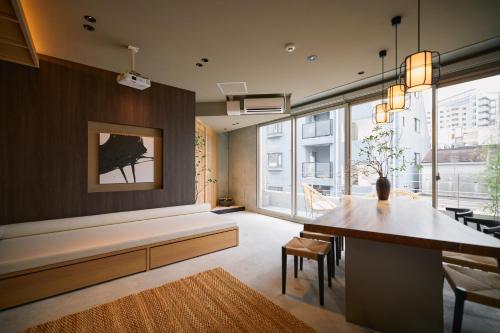 a living room with a table and a large window at Tsubomi Shibuya in Tokyo