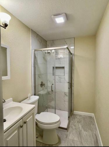 a bathroom with a shower and a toilet and a sink at Private Room "Date" by UW in Seattle