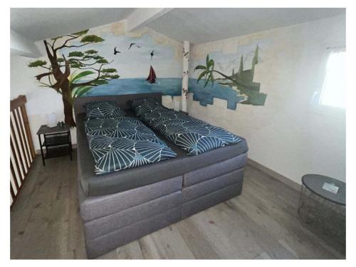 une chambre avec un lit avec un tableau sur le mur dans l'établissement Maison de vacances Kurt dans le sud de la France, à Portiragnes