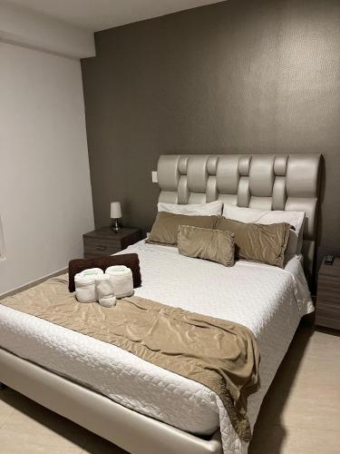 a bedroom with a large bed with towels on it at Hotel Roma VIP Pereira in Pereira