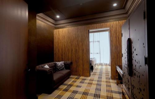 a living room with a couch and a window at 1969 D'Kelly Hotel in Ipoh