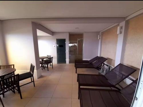 a room with couches and tables and chairs at Luxury Studio - Aeroporto GRU in Guarulhos