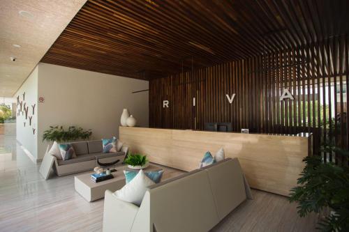 a lobby with two couches and a reception desk at Luxury Condo of 4 Bedrooms in Cancún