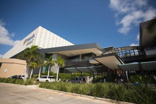 a building with a car parked in front of it at Luxury Condo of 4 Bedrooms in Cancún