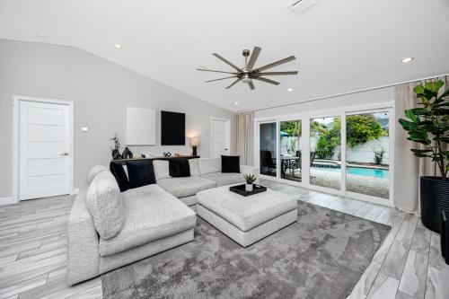 a living room with a couch and a ceiling fan at NEW! Palm Harbor Hideaway - Beautiful, Spacious 4BR Home with Amazing Pool in Palm Harbor