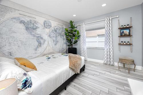 a bedroom with a large map of the world on the wall at NEW! Palm Harbor Hideaway - Beautiful, Spacious 4BR Home with Amazing Pool in Palm Harbor