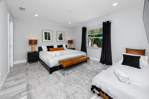 a bedroom with two beds and a window at NEW! Palm Harbor Hideaway - Beautiful, Spacious 4BR Home with Amazing Pool in Palm Harbor