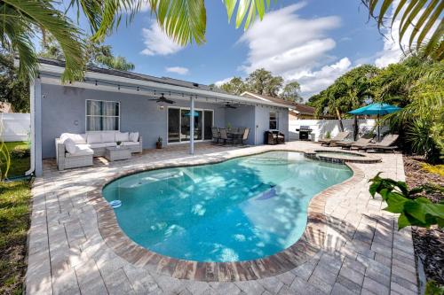 a swimming pool in the backyard of a house at NEW! Palm Harbor Hideaway - Beautiful, Spacious 4BR Home with Amazing Pool in Palm Harbor