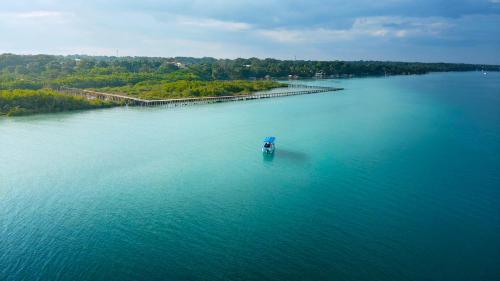 a small boat in the middle of a large body of water at Ade Hotel Bacalar in Bacalar