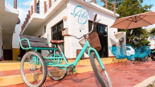 a blue bike parked in front of a building at Ade Hotel Bacalar in Bacalar