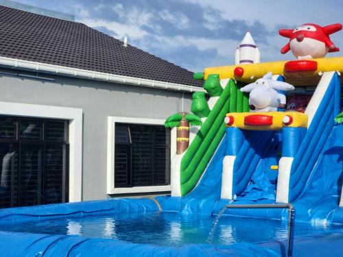 a water park with a water slide in a pool at Dirgahayu Homestay III Serindit in Kulim