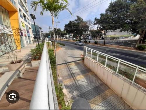 a street with a fence and a road with a car at Studio Luxo Próx Aeroporto GRU in Guarulhos