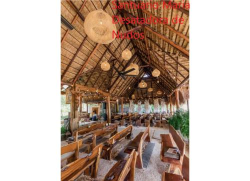 a church with wooden chairs in a room at Beautiful condo in Cancun! Dreams Lagoon in Cancún