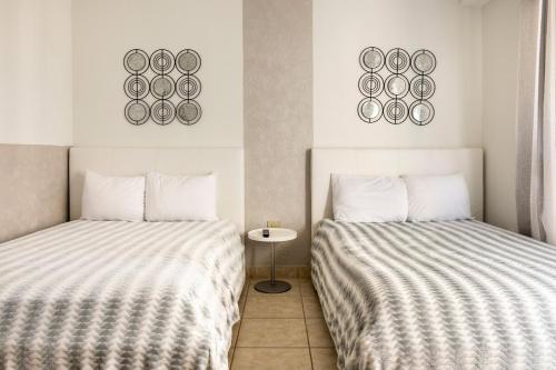 two beds sitting next to each other in a room at Luxury Beach Front Condo Balcony Pool and Jacuzzi in Buena Vista