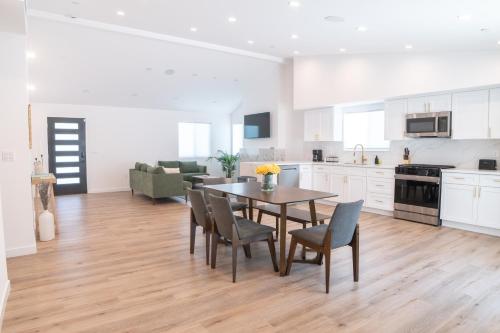a kitchen and dining room with a table and chairs at A Brand New Home In Los Angeles in Van Nuys County Court Heliport