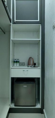a shelf in a kitchen with a pot on it at Captain's Cabin Resort - Naval Heritage (Swimming Pool) in Kota Bharu
