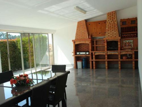 a dining room with a glass table and a fireplace at Quaint & Peaceful Barcelos Villa 3 Bedrooms Villa Mycenaean Private Pool & Large Garden North Portugal in Barcelos