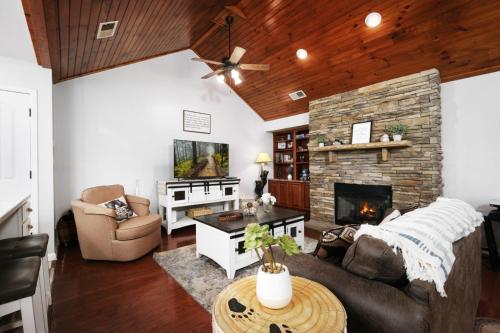 a living room with a couch and a fireplace at Sweet Pea Cottage Updated furnishings arcade game HOA Community Outdoor Pool in Pigeon Forge