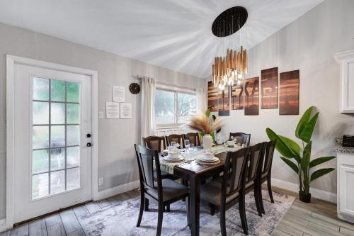 a dining room with a black table and chairs at Near Sea World Hot Tub Swing Set BBQ Yard Games in San Antonio